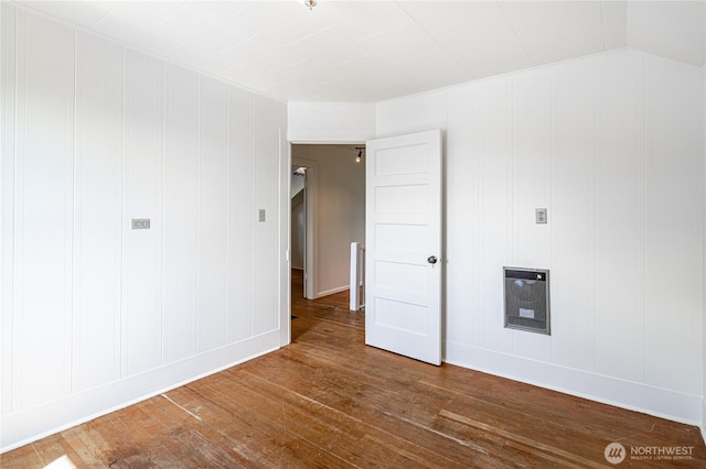 595 Division St, Manson, WA 98831 - unfurnished room with wood-type flooring, a decorative wall, and baseboards