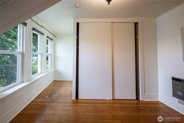 595 Division St, Manson, WA 98831 - unfurnished bedroom with hardwood / wood-style floors, heating unit, a closet, and baseboards