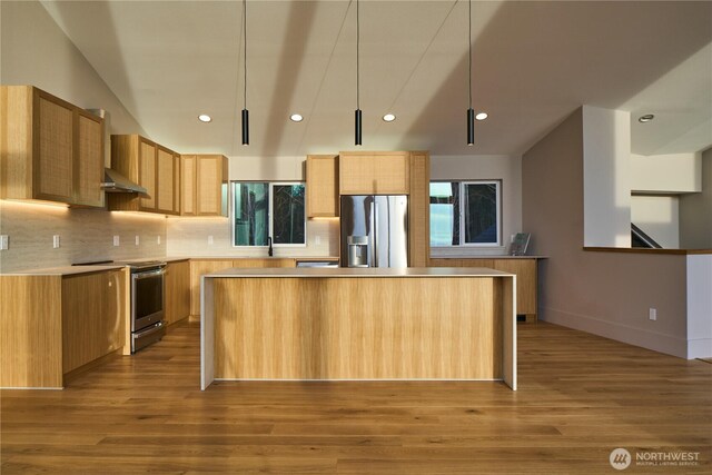 27208 J Ln, Ocean Park, WA 98640 - kitchen with stainless steel appliances, wall chimney exhaust hood, recessed lighting, wood finished floors, and a center island