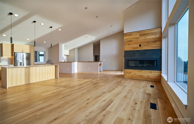27208 J Ln, Ocean Park, WA 98640 - unfurnished living room with vaulted ceiling, light wood-style flooring, recessed lighting, and a glass covered fireplace
