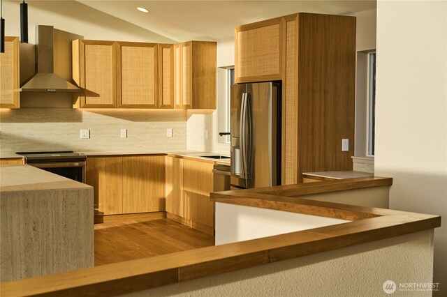 27208 J Ln, Ocean Park, WA 98640 - kitchen featuring wall chimney exhaust hood, appliances with stainless steel finishes, tasteful backsplash, light wood-type flooring, and light countertops