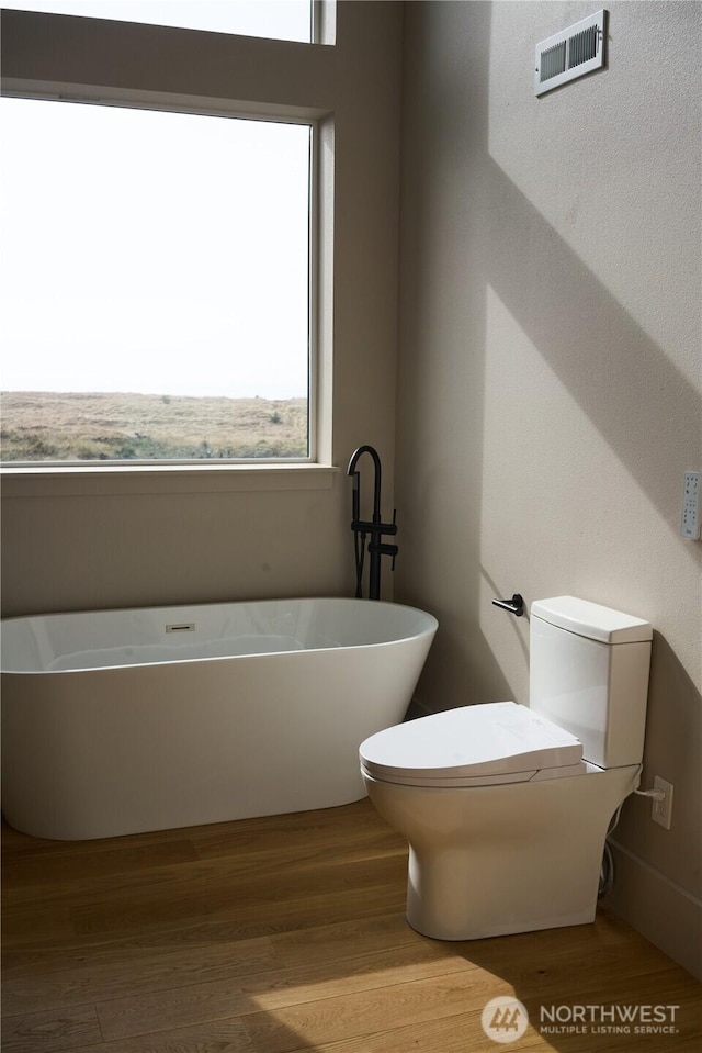27208 J Ln, Ocean Park, WA 98640 - bathroom featuring toilet, wood finished floors, and a freestanding tub