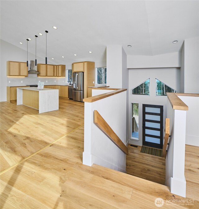 27208 J Ln, Ocean Park, WA 98640 - kitchen featuring stainless steel appliances, wall chimney range hood, recessed lighting, a center island, and light countertops