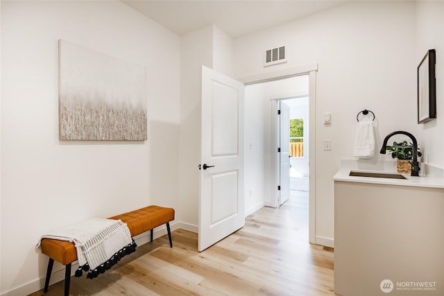 2818 Hazelwood Dr, Blaine, WA 98230 - hallway with light wood-style floors, a sink, and baseboards