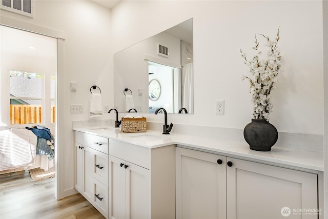 2818 Hazelwood Dr, Blaine, WA 98230 - full bathroom featuring double vanity, connected bathroom, and wood finished floors