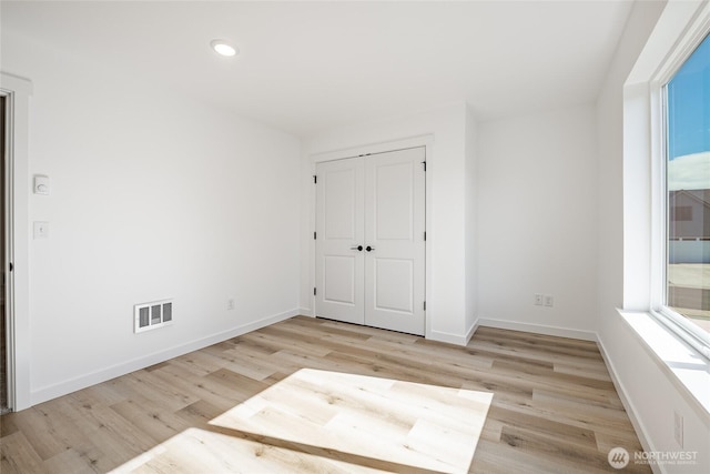 2818 Hazelwood Dr, Blaine, WA 98230 - unfurnished bedroom featuring light wood finished floors, baseboards, and recessed lighting