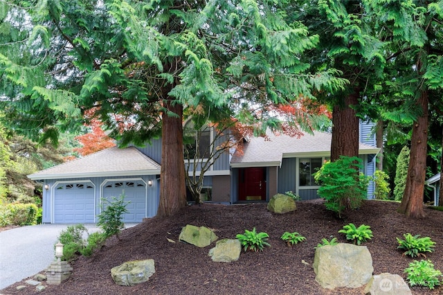 11423 NE 104th St, Kirkland, WA 98033 - tri-level home featuring a garage and a shingled roof