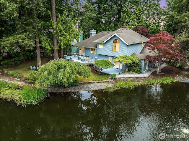 11423 NE 104th St, Kirkland, WA 98033 - rear view of property with a chimney, a deck with water view, and driveway