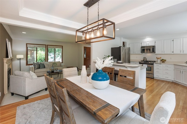 11423 NE 104th St, Kirkland, WA 98033 - dining space featuring ornamental molding, light wood-type flooring, recessed lighting, and a chandelier