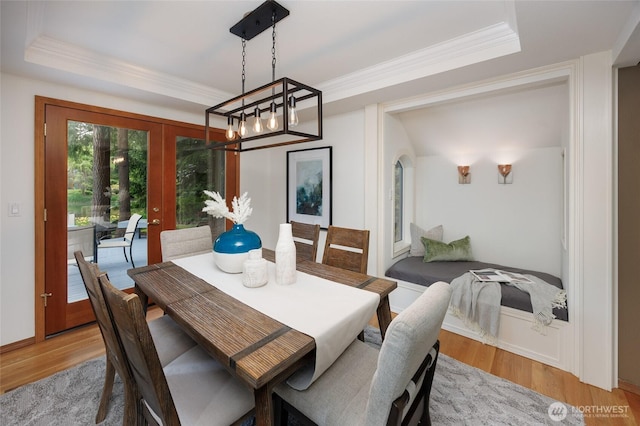 11423 NE 104th St, Kirkland, WA 98033 - dining room with french doors, light wood-type flooring, a raised ceiling, a chandelier, and crown molding