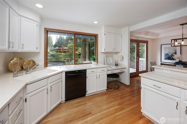 11423 NE 104th St, Kirkland, WA 98033 - kitchen with black dishwasher, white cabinetry, light countertops, light wood-type flooring, and pendant lighting