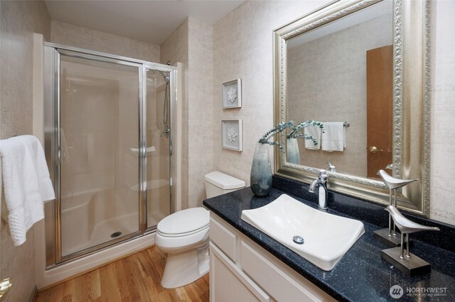 11423 NE 104th St, Kirkland, WA 98033 - bathroom featuring wood finished floors, vanity, a shower stall, and toilet