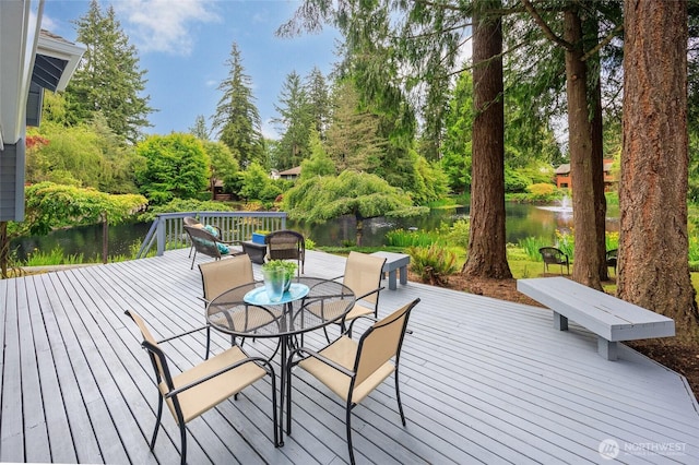 11423 NE 104th St, Kirkland, WA 98033 - wooden deck featuring a water view, view of scattered trees, and outdoor dining area