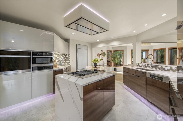 13707 SE 51st Pl, Bellevue, WA 98006 - kitchen with stainless steel appliances, modern cabinets, light tile patterned floors, light stone countertops, and recessed lighting