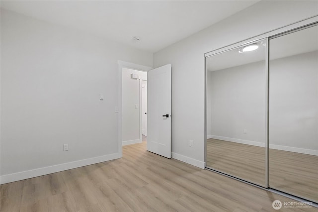 50 Lake Louise Dr, Bellingham, WA 98229 - unfurnished bedroom featuring light wood finished floors, a closet, and baseboards