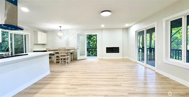 50 Lake Louise Dr, Bellingham, WA 98229 - living room featuring light wood-type flooring, recessed lighting, baseboards, and a glass covered fireplace