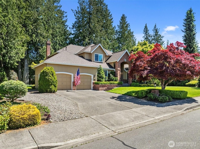 3924 Montgomery Ct, Mount Vernon, WA 98274 - traditional-style house featuring a garage, concrete driveway, a front yard, and a chimney