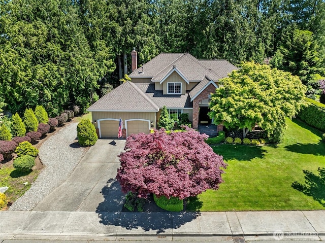 3924 Montgomery Ct, Mount Vernon, WA 98274 - view of front of house with an attached garage, a front yard, concrete driveway, and a chimney