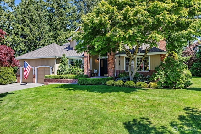 3924 Montgomery Ct, Mount Vernon, WA 98274 - view of property hidden behind natural elements featuring a garage, driveway, a front yard, and brick siding