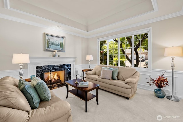 3924 Montgomery Ct, Mount Vernon, WA 98274 - living area with a tray ceiling, ornamental molding, wainscoting, light carpet, and a high end fireplace