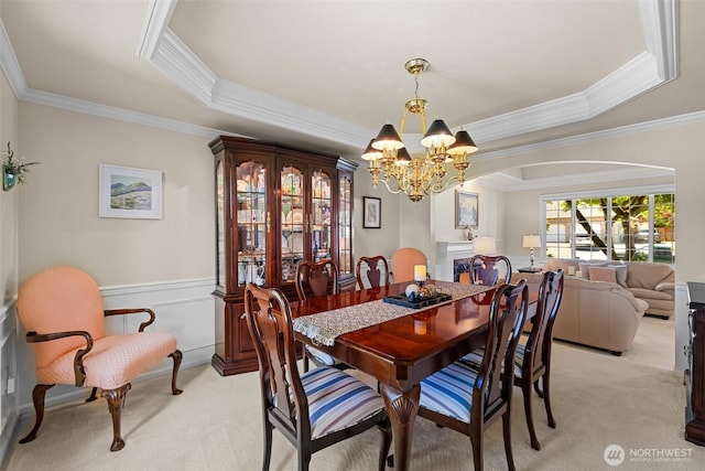 3924 Montgomery Ct, Mount Vernon, WA 98274 - dining space featuring arched walkways, light colored carpet, ornamental molding, a chandelier, and a tray ceiling