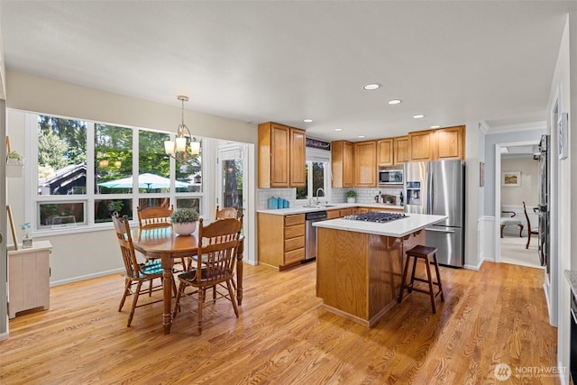 3924 Montgomery Ct, Mount Vernon, WA 98274 - kitchen featuring appliances with stainless steel finishes, a chandelier, a sink, light countertops, and healthy amount of natural light