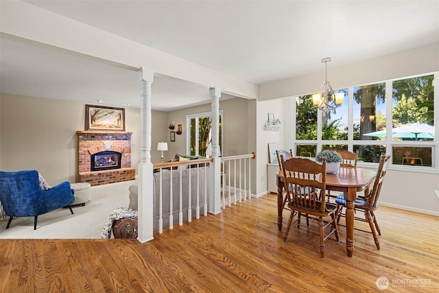 3924 Montgomery Ct, Mount Vernon, WA 98274 - dining space featuring a brick fireplace, plenty of natural light, and light wood-type flooring