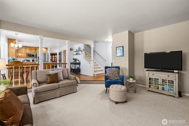 3924 Montgomery Ct, Mount Vernon, WA 98274 - carpeted living room featuring stairs, a chandelier, decorative columns, and baseboards