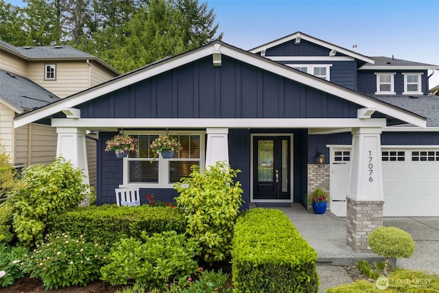 craftsman house featuring a garage, covered porch, board and batten siding, and a shingled roof