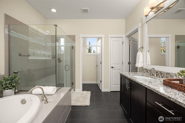 bathroom featuring tile patterned floors, a shower stall, vanity, a bath, and baseboards