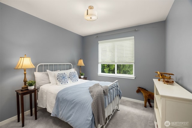carpeted bedroom featuring baseboards