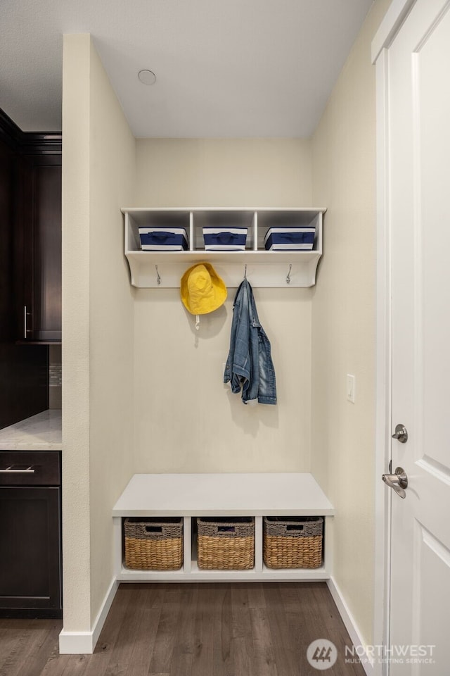mudroom featuring dark wood-style flooring and baseboards