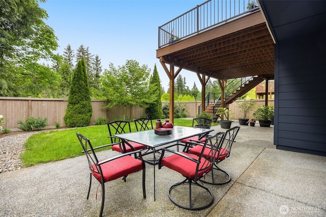 view of patio / terrace with stairs, outdoor dining area, and a deck