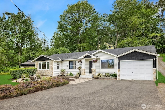 23516 20th Ave W, Bothell, WA 98021 - view of front of house featuring stone siding, an attached garage, and asphalt driveway