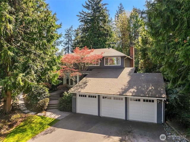 9209 SE 57th St, Mercer Island, WA 98040 - view of front facade featuring a chimney and a garage