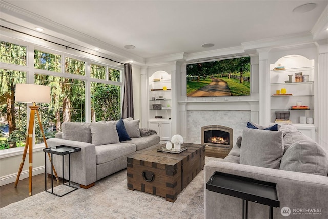 9209 SE 57th St, Mercer Island, WA 98040 - living area with crown molding, built in features, a lit fireplace, wood finished floors, and baseboards