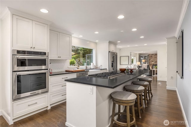 9209 SE 57th St, Mercer Island, WA 98040 - kitchen with stainless steel appliances, white cabinetry, dark countertops, dark wood-style floors, and recessed lighting