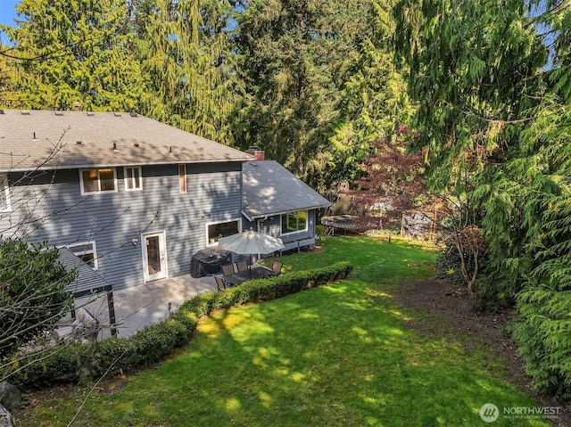 9209 SE 57th St, Mercer Island, WA 98040 - view of home's exterior featuring a yard, a chimney, and a patio area