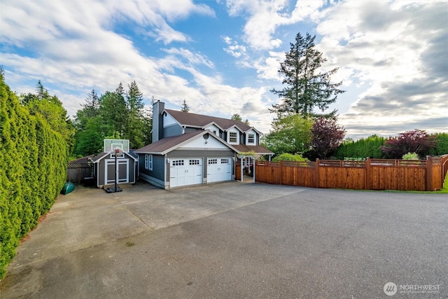 4279 H Street Rd, Blaine, WA 98230 - view of home's exterior featuring driveway, an attached garage, and a chimney