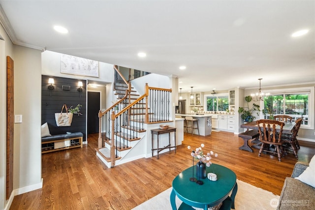 4279 H Street Rd, Blaine, WA 98230 - living room with stairway, a chandelier, ornamental molding, light wood-type flooring, and recessed lighting