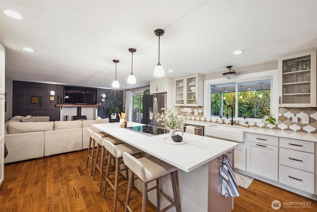 4279 H Street Rd, Blaine, WA 98230 - kitchen featuring stainless steel appliances, a sink, a breakfast bar area, white cabinetry, and recessed lighting