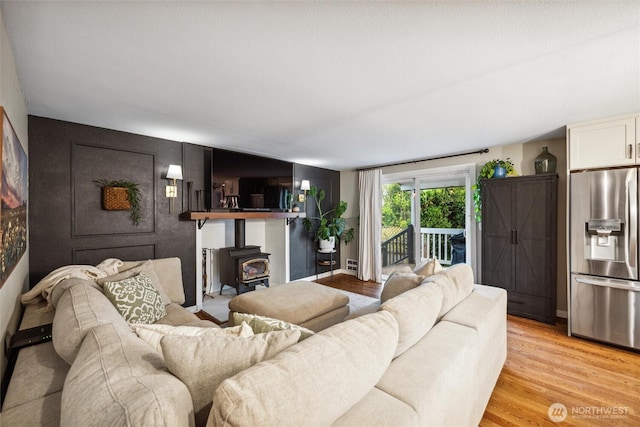 4279 H Street Rd, Blaine, WA 98230 - living room featuring a wood stove and light wood-style floors