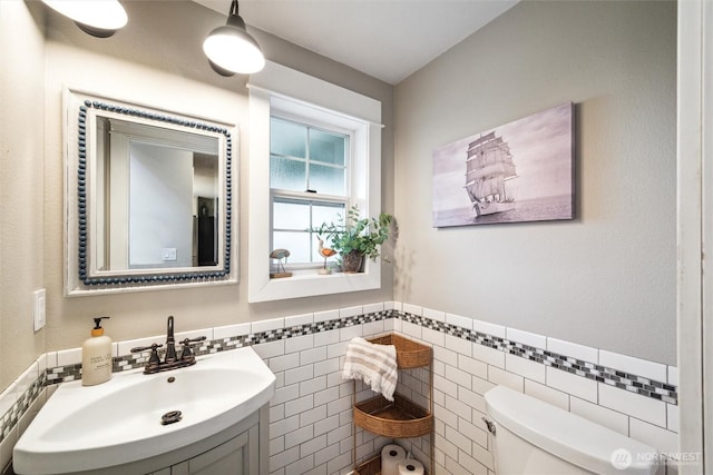 4279 H Street Rd, Blaine, WA 98230 - half bath featuring tile walls, toilet, wainscoting, and vanity
