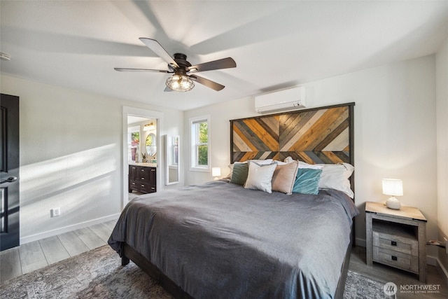 4279 H Street Rd, Blaine, WA 98230 - bedroom featuring a wall mounted AC, wood finished floors, baseboards, a ceiling fan, and ensuite bathroom