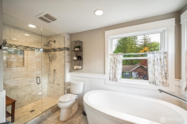 4279 H Street Rd, Blaine, WA 98230 - bathroom with a freestanding bath, a shower stall, wainscoting, toilet, and recessed lighting