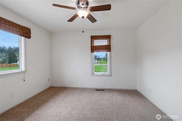211 Blake St, Enumclaw, WA 98022 - unfurnished room with plenty of natural light, carpet flooring, and a ceiling fan