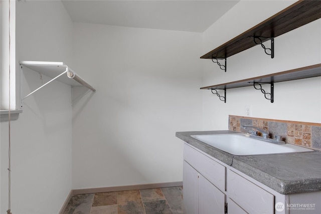 211 Blake St, Enumclaw, WA 98022 - washroom featuring baseboards, a sink, and stone finish flooring