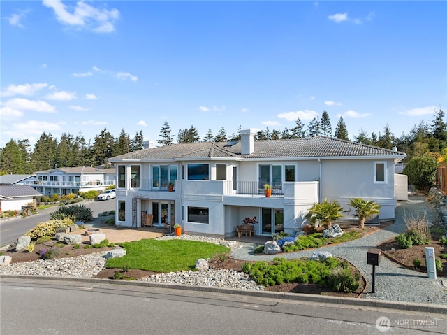 4807 Glasgow Way, Anacortes, WA 98221 - view of front of property featuring a balcony, a patio area, stucco siding, and a tiled roof