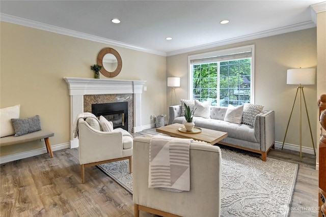 26309 187th Ct SE, Covington, WA 98042 - living area with crown molding, wood finished floors, a high end fireplace, baseboards, and recessed lighting