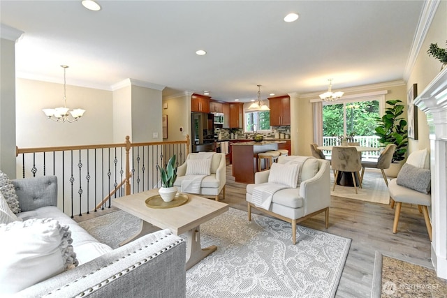 26309 187th Ct SE, Covington, WA 98042 - living room featuring a chandelier, ornamental molding, light wood-type flooring, and recessed lighting